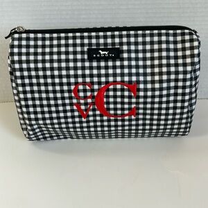 Scout cosmetic bag. Black and white checkered with “CV” embroidered in red.
